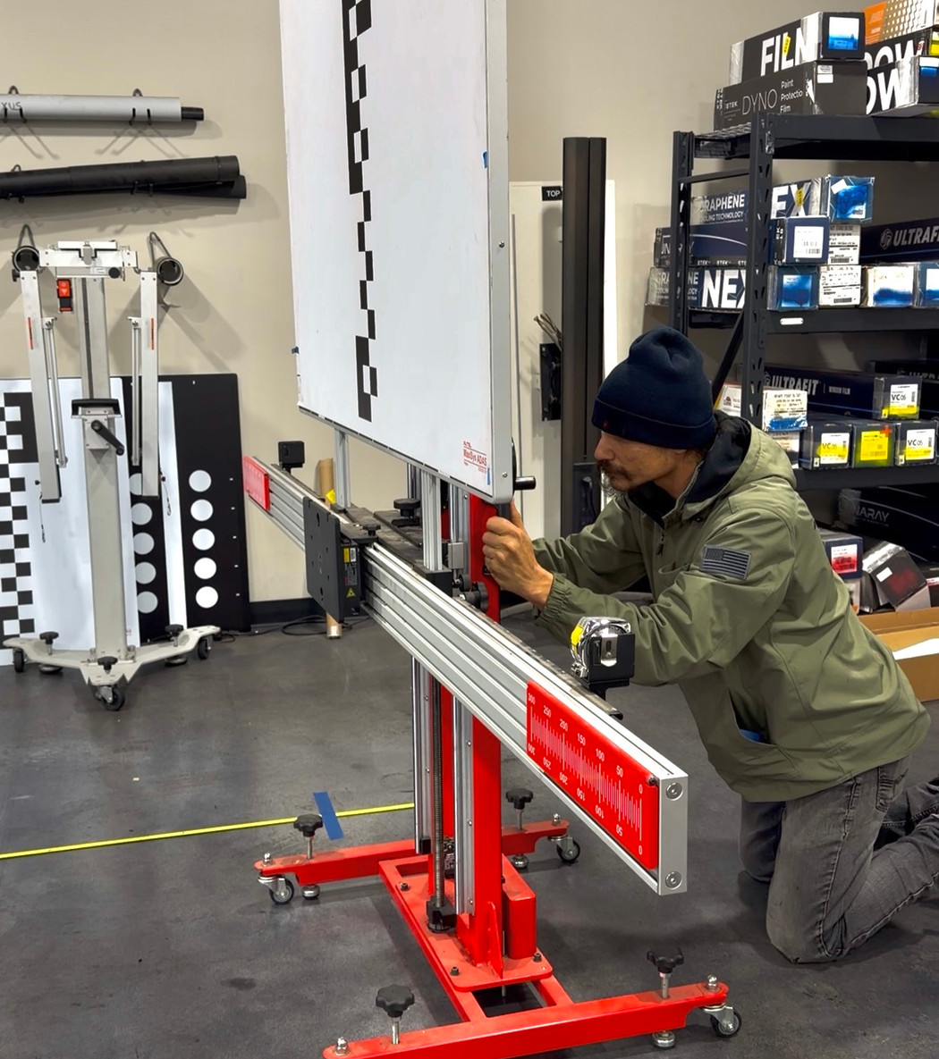 Technician setting up an ADAS calibration target rig